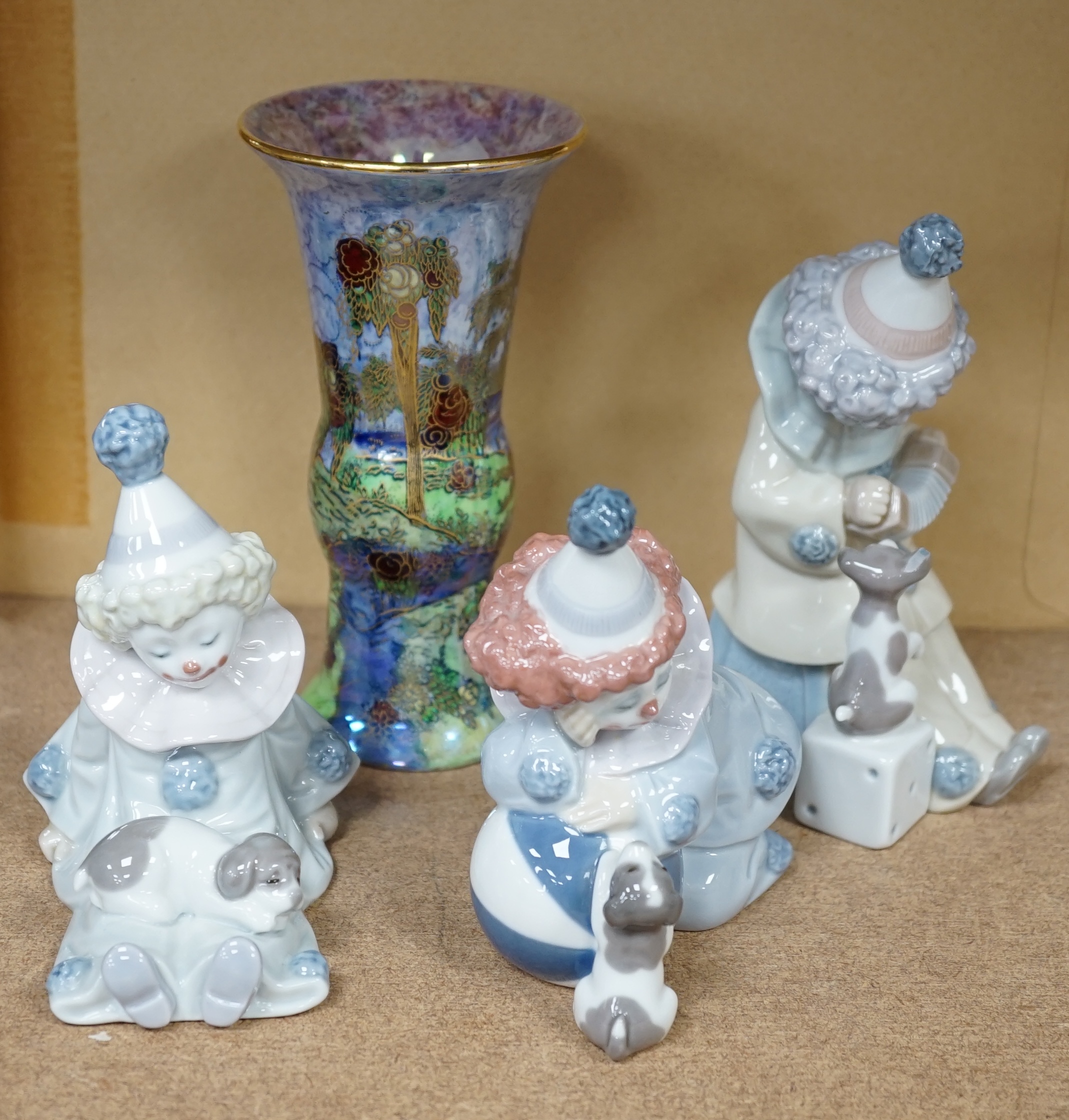 Three Lladro clowns and a Carlton ware dragon and cloud pattern vase, stamped to the base, largest 16cm high. Condition - fair, a few small chips